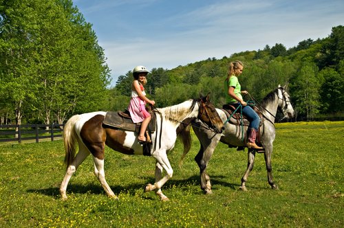 Two girls riding horses 