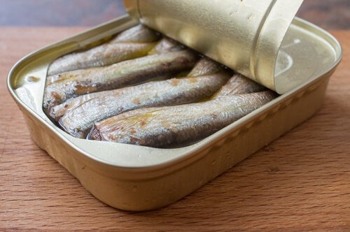 An open tin of sardines.
