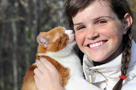 Cat licking his human's hair