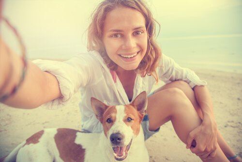A woman taking a selfie with her dog