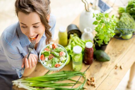 Young woman eating fresh vegetables, going to stop eating meat.