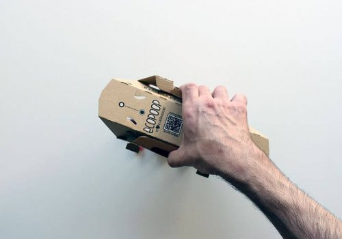 A hand demonstrating the scooping action of an Ecopoop.