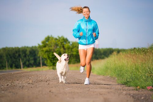 A beautiful dog running with his owner.