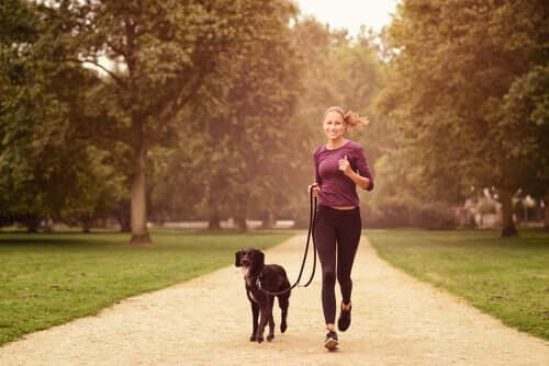 A woman running with her dog.