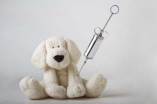 A toy dog with an injection needle.