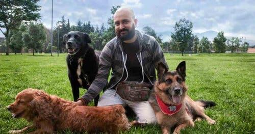 A man with three dogs.