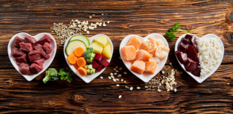 Types of food arranged in heart-shaped bowls.